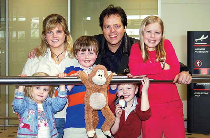 Jimmy Osmond taking a picture with his family.